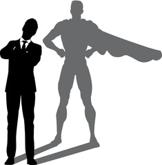A superhero business man revealed by his shadow silhouette as a super hero in a cape