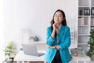 Confident Asian Businesswoman Standing in Office, Looking at Camera with Professional Demeanor....