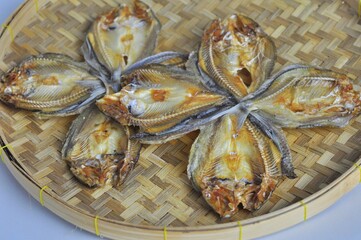 Sun-dried fish on bamboo container.  Thai food. Sun dried fish is a food preservation to keep for a long time