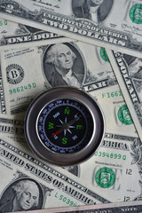 Compass and banknotes. US dollars. Navigation in the financial world.