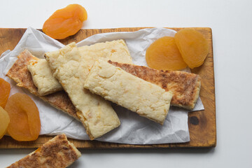 Healthy homemade sugar free grain cookies with dried apricots on white paper, selective focus