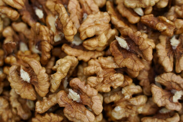 Peeled walnuts. Peeled walnuts background texture. Walnut wallpaper. Kernel.