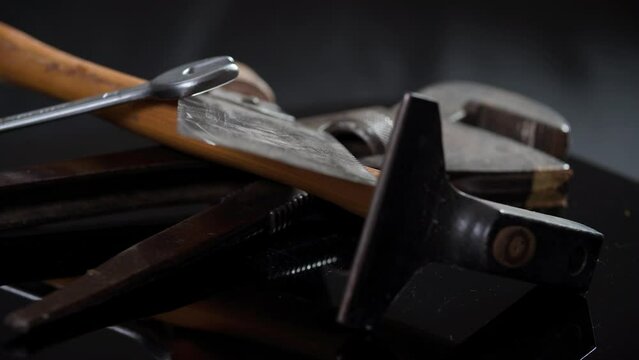 pipe wrench hammer and saw rotating on turntable