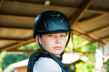 Beautiful face of a young horsewoman in sportswear