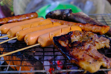 Chicken sausage grilled on charcoal fire
