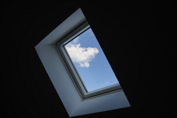 Attic window to blue sky landscape. Window in the roof, serenity place to relax.