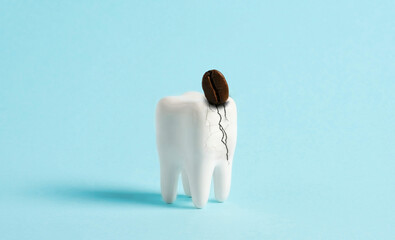 Coffee bean breaks white human tooth. Minimal art poster of dental problems dental advertising.