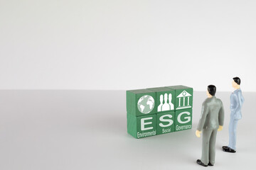 ESG(Environmental,Social,Governance), Responsible Business concept.,Businessman looking a green wooden cube with ESG text and icon for Building Sustainable Future perfect for industrial,business idea.
