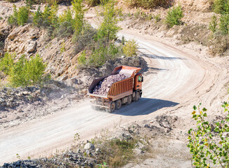 Heavy Dump Truck Carries Rock in a Stone Quarry
