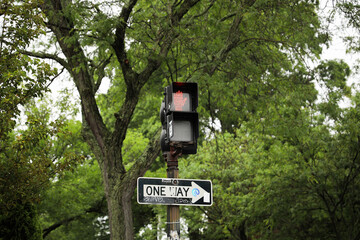 street light with traffic signals, displaying the colors red, green, and yellow. The walking sign indicates pedestrian safety and the flow of urban life
