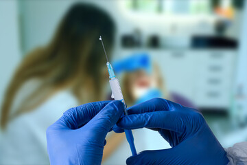 close up of male doctor holding syringe with injection.