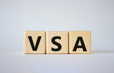 VSA - Volume Spread Analysis symbol. Wooden cubes with word VSA. Beautiful white background. Business and Volume Spread Analysis concept. Copy space.