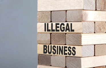 The text on the wooden blocks ILLEGAL BUSINESS