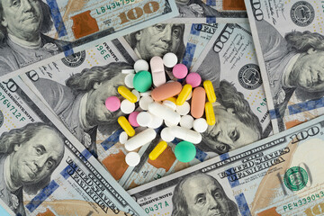 Pills on the background of the dollar. The concept of expensive medicine