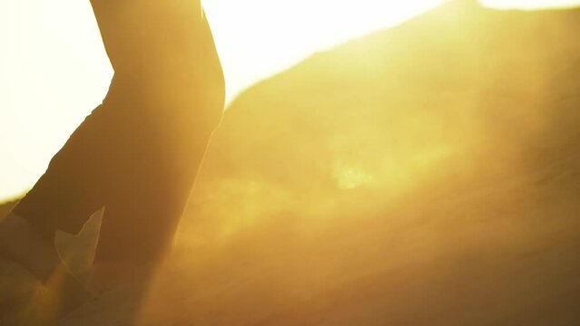 close up video of feet of an adult woman climbing up the sand hill at sunset. person walking barefoot slow motion. beautiful desert video. Sahara, Africa, Gobi