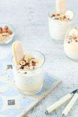 Milk mousse dessert with nuts in glasses	