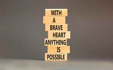 Possible symbol. Concept words With a brave heart anything is possible on wooden blocks on a...