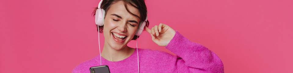 White young woman wearing sweater listening music and singing