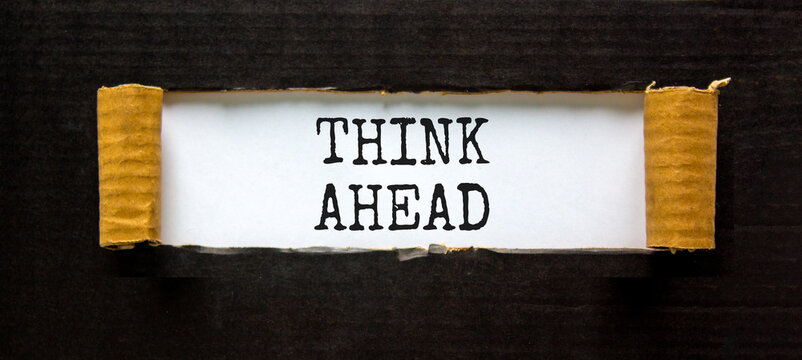 Think ahead symbol. Concept words Think ahead on beautiful white paper on a beautiful black background. Business, support, motivation psychological and think ahead concept. Copy space