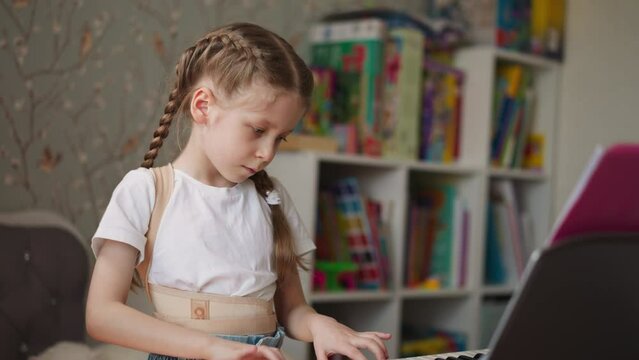 Girl with spinal injury plays piano making smooth movements