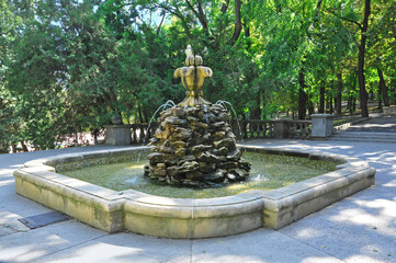 Old beautiful fountain in the city park on a sunny day