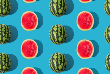 You're one in a melon! Trendy summer fruit pattern made of watermelon on light blue background. Natural food background concept. Minimal watermelon pattern idea. Summer fruit aesthetic. Flat lay.
