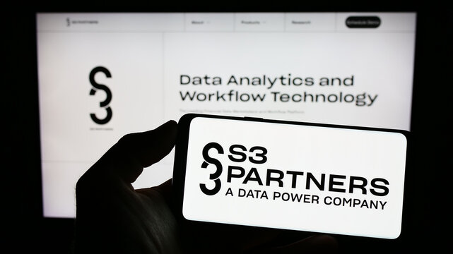 Stuttgart, Germany - 06-18-2023: Person holding mobile phone with logo of American data analytics company S3 Partners LLC on screen in front of web page. Focus on phone display.