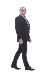 side view. confident business man striding forward
