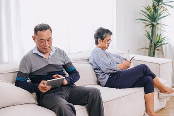 Obraz premium adult senior sitting away no talking social media technology device addicted. Smartphone or internet addiction at home.
