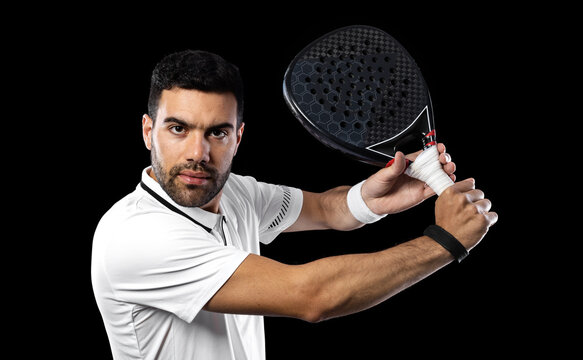 Padel tennis player. Man athlete with paddle tenis racket on black background. Sport concept. Download a high quality photo for sports website.