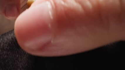 Man wipes transparent spectacles of ophthalmology glasses with napkin on black background. Professional eyewear for eyesight correction macro