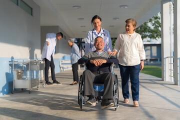 Fototapeta na wymiar Doctor pushing a wheelchair.