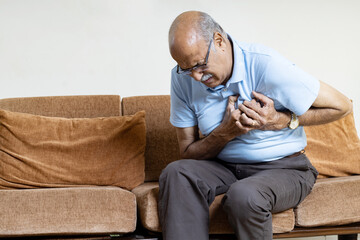 Senior Man in pain with hand on Chest due to heart attack ,