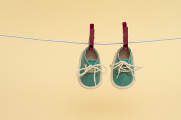 Children's sneakers hanging on a clothesline. Newborn concept