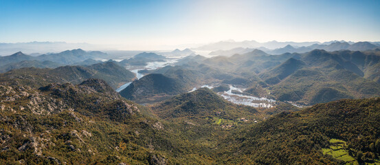 Autumn aerial view of Lake Skodar with its picturesque shores and misty hills in the distance, Montenegro.