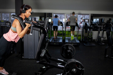 Fototapeta na wymiar Female workout on leg mashine in the gym