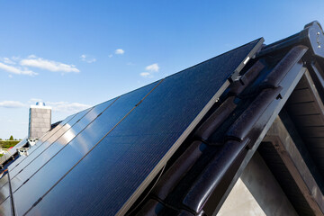 Modern solar panels on a gable roof - obrazy, fototapety, plakaty