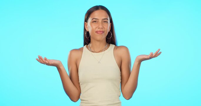 Confused, doubt and woman face in studio with emoji hands for decision, choice or puzzled on blue background. Questions, why and portrait of female person asking, dont know and shrug for option