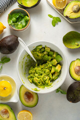 Guacamole in a bowl, cooking homemade avocado mash dip. 