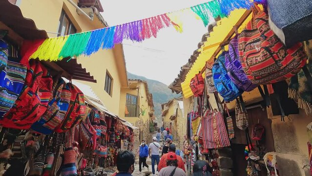 Unrecognizable tourist people walking in village Ollantaytambo, Cusco, Peru. 