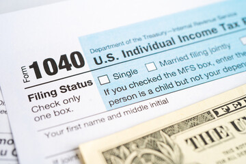 Tax Return form 1040 and dollar banknote, U.S. Individual Income. - obrazy, fototapety, plakaty