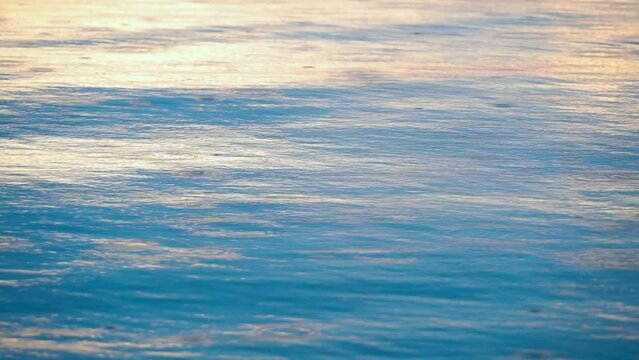 Rain drops falling in river ripple blue color water.
