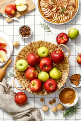 Fototapeta na wymiar Apple. Fresh raw juicy red and green apples in a basket on a kitchen table with ingredients for cooking Thanksgiving autumn season apple pie, top view