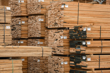 Close up of stacks of lumber being stored in a warehouse - obrazy, fototapety, plakaty