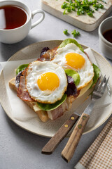 Breakfast food, fried eggs with bacon on toast. 