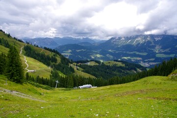 Tyrolean grasslands and mountains with cable car in the distance. Söll, Austria.