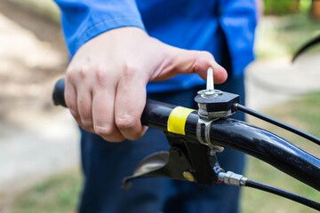 A man adjusts the throttle on the handle of a walk-behind tractor before starting work. Running in, industry