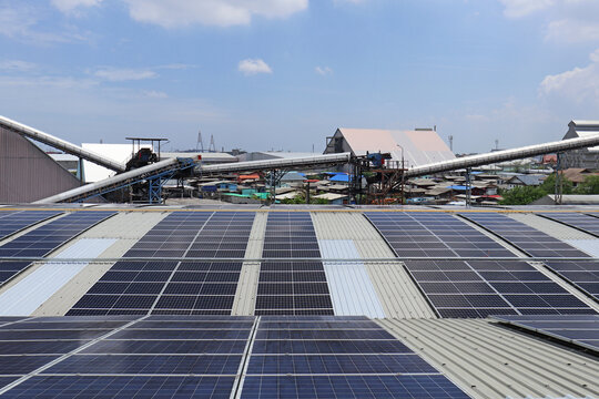 Solar PV System on Warehouse Roof with Conveyer Background
