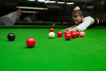 Snooker player before shot , green cloth
