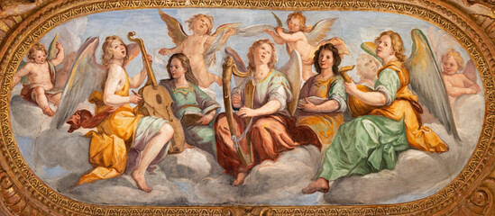 GENOVA, ITALY - MARCH 5, 2023: The fresco of angels choir with the music instrumenst in the church Chiesa del Gesu by Giovanni Carlone from 17. cent.